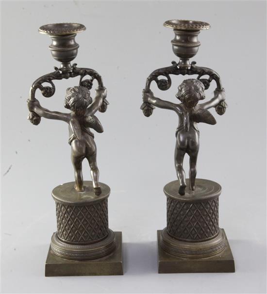 A pair of early 19th century bronze candlesticks, 10in.